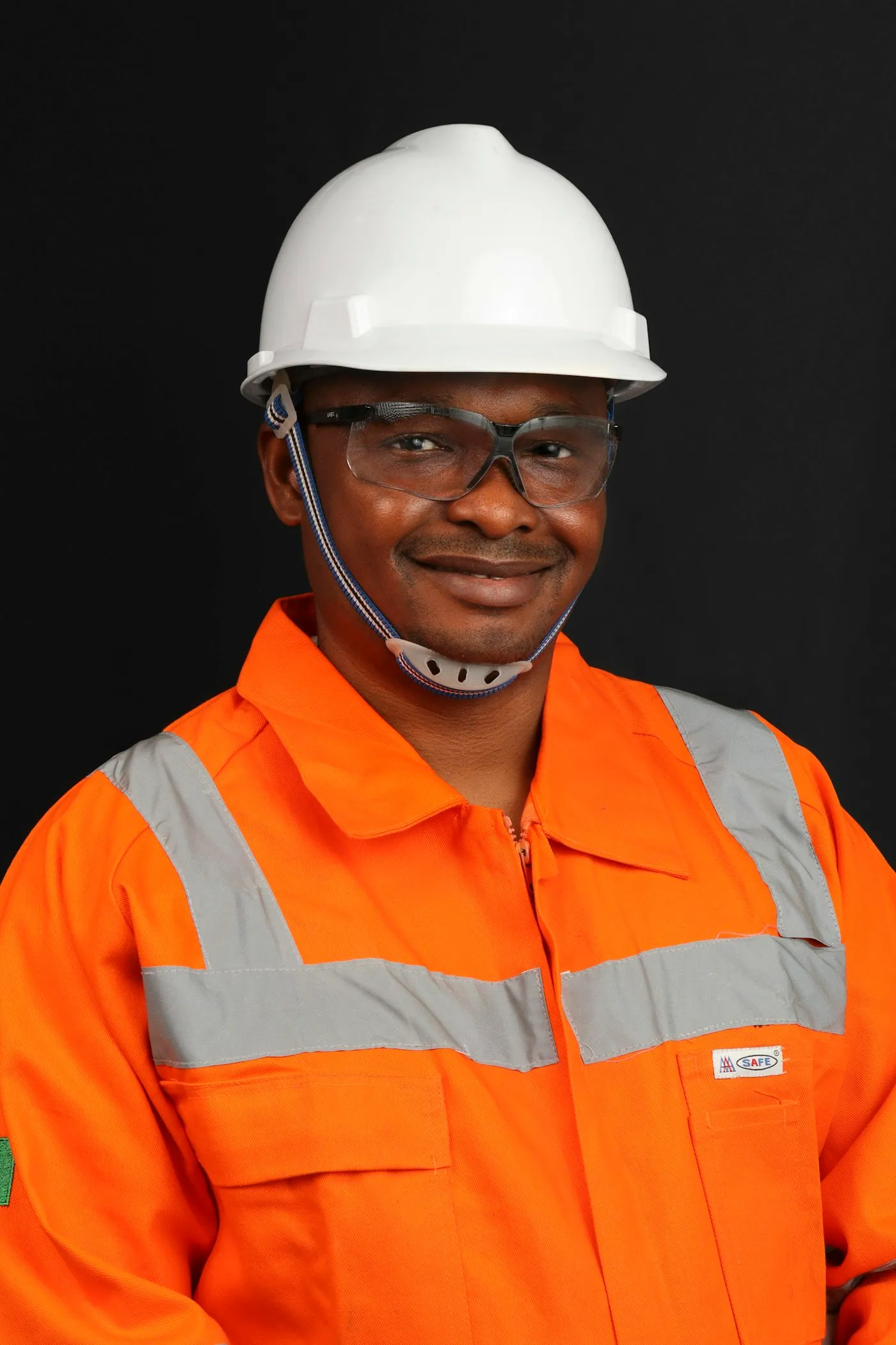Field technician wearing a hard hat and high-visibility coveralls