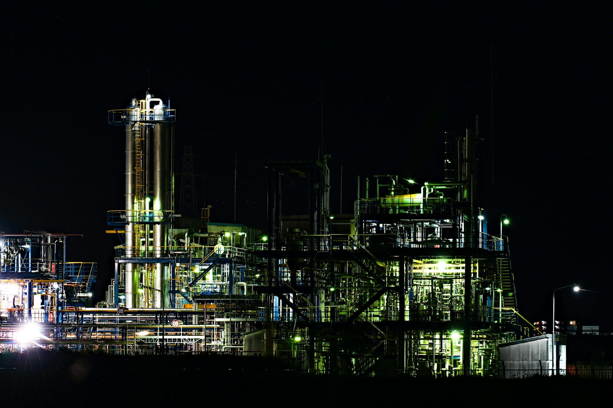 Industrial plant at night with illuminated process units